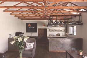 a bar with a couch and a counter in a room at Warm Karoo in Bloemfontein