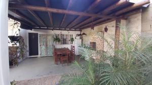 a patio with a table and some plants at Lolosa Suítes in Ubatuba