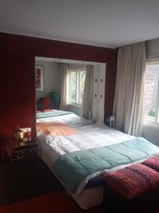 a bedroom with two beds and two windows at ETAGE voor 1-2 pers in NIJMEGEN-Centrum in Nijmegen