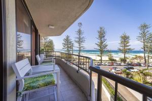a balcony with a view of the beach at The Coconut Crib- Waterfront Burleigh Beach in Gold Coast