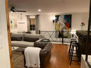 a living room with a couch and a table at Five-Star Historic Boyd Harvey Carriage House in Knoxville +14 photos