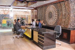 a group of people sitting at a bar in a restaurant at HLVGRANDINN in Bangalore