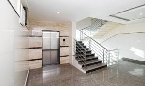 a staircase in a house with a glass door at HLVGRANDINN in Bangalore