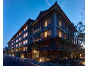 a large building with many windows on a street at Hotel The Celestine Kyoto Gion in Kyoto