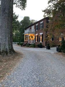 a house with a large tree in front of it at Boyd Harvey Main House & Carriage House in Knoxville