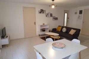 a living room with a couch and a table at Historical center of Pézenas in Pézenas