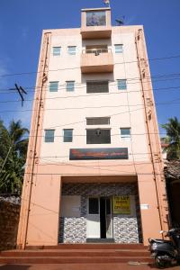 a tall building with a clock on top of it at RAJE SAMBHAJI GUEST HOUSE in Belgaum