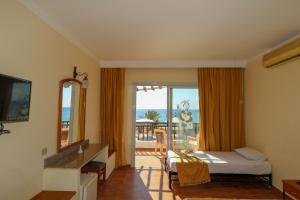 a bedroom with a bed and a view of the ocean at Panda resort in Dahab