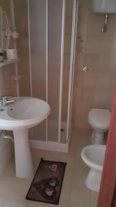 a bathroom with a white sink and a toilet at Hotel Villa del Sole in Porto Cesareo