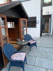 a patio with two chairs and a table at Griff Cottage, Skinningrove in Skinningrove