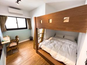 a bedroom with a bunk bed and a desk at Small Island Homestay in Tainan