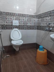 a bathroom with a toilet and a sink at HOTEL SUKHMANI in Guwahati