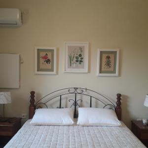 ein Schlafzimmer mit einem Bett mit zwei Kissen darauf in der Unterkunft Lagonissi Summer House in Lagonisi + 22 Fotos