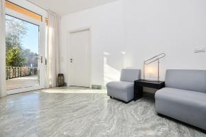 een woonkamer met een bank en een stoel bij La Pervinca Apartments in Malcesine