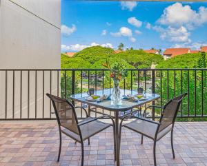 a table and chairs on a patio with a balcony at Kaanapali Shores 422 in Lahaina