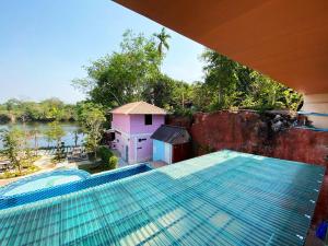 a swimming pool with a view of a river at Keree Lakeview in Chanthaburi