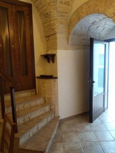 a hallway with stairs and a door in a house at Soggiornare In Centro in Alberobello