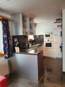 a kitchen with white cabinets and a counter top at Chalet Alba A in Bürchen