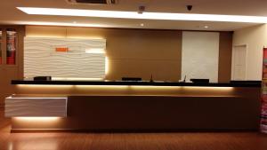 a lobby with a large reception desk in a building at Smart Hotel in Seremban