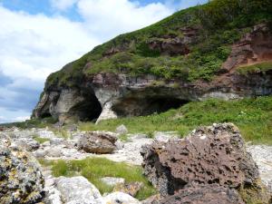 a rocky mountain with a cave in the side of it at Kinloch Hotel, Isle of Arran in Blackwaterfoot