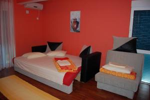 a bedroom with a bed and a chair in it at 500 Meters from Grate Beach, App 1 in Ulcinj