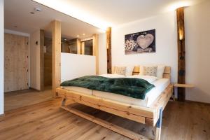 a bedroom with a bed on a wooden platform at Der Postwirt in Kipfenberg