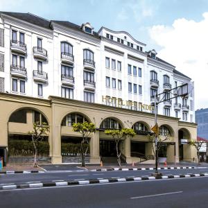 a large white building on the side of a street at Hotel Des Indes Menteng in Jakarta