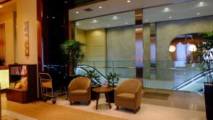 a lobby with chairs and a table in a building at Lotte City Hotel Kinshicho in Tokyo