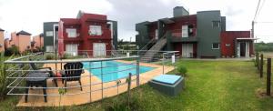 a house with a swimming pool in front of a house at 5 SOLES CHAJARI in Chajarí
