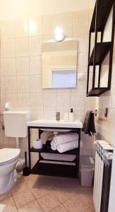 a bathroom with a sink and a toilet at Studio Dora Malinska in Malinska