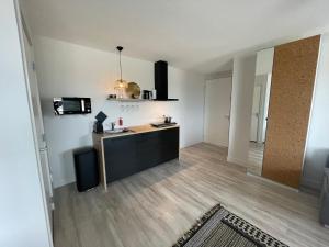 an empty room with a kitchen and a living room at Marina Strand Appartement Lemmer in Lemmer
