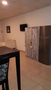 a kitchen with a stainless steel refrigerator in a room at Ananá in Federación