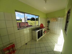 a kitchen with green walls and a window at Apartamento São Pedro SP in São Pedro +15 photos