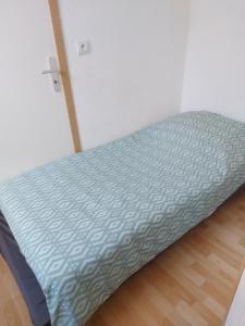 a bed sitting in a room next to a door at Chez sylvie in Morez