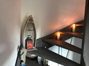 a staircase with a lantern in a room at Haus Willy Dornum mit Wintergarten und Wallbox in Dornum