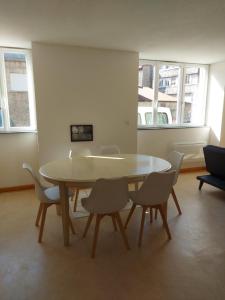 uma sala de jantar com mesa e cadeiras em Chez sylvie em Morez