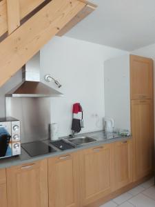 a kitchen with a sink and a stove at Chez sylvie in Morez