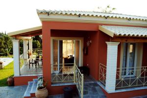 a house with a porch and a patio at Villa Grecia in Liapades