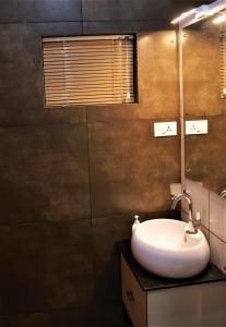 a bathroom with a sink and a mirror at Peakaavu Cottages in Idukki