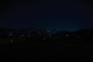 a view of a city at night at Peakaavu Cottages in Idukki