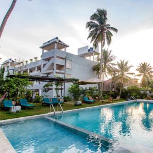 an image of a swimming pool in front of a building at Esprit d'Ici Hotel in Mirissa