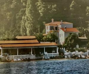 a large house on the shore of a body of water at Villa Persephone in Megali Ammos