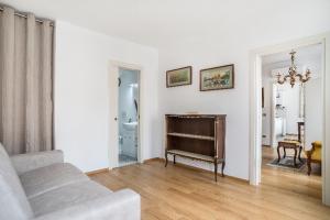 a living room with a couch and a piano at Casa Bastianello favolosa vista sul Canale Vena in Chioggia +18 photos