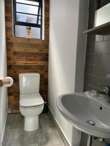 uma casa de banho com um WC e um lavatório em RElaxed city living em Port Elizabeth