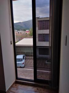 an open window with a view of a parking lot at Casa Bertha Hotel y Servicios SAS in Nobsa