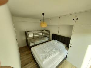 a small room with a bed and a cabinet at zeedijk westende in Westende