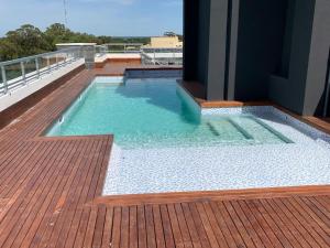 a swimming pool on the deck of a building at Departamento con Amenities in Pinamar