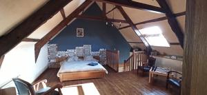 a bedroom with a bed in a attic at La Ferme du Père in Kermorocʼh