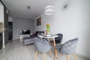 a living room with a table and chairs at APARTAMENT KAMILA in Gdańsk