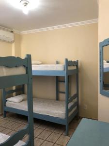 two bunk beds in a room with a mirror at Cobertura Frente Mar in Porto Belo
